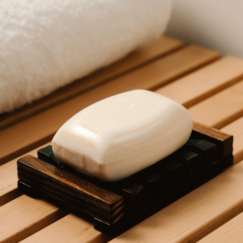 Coconut soap bar on a wooden soap dish